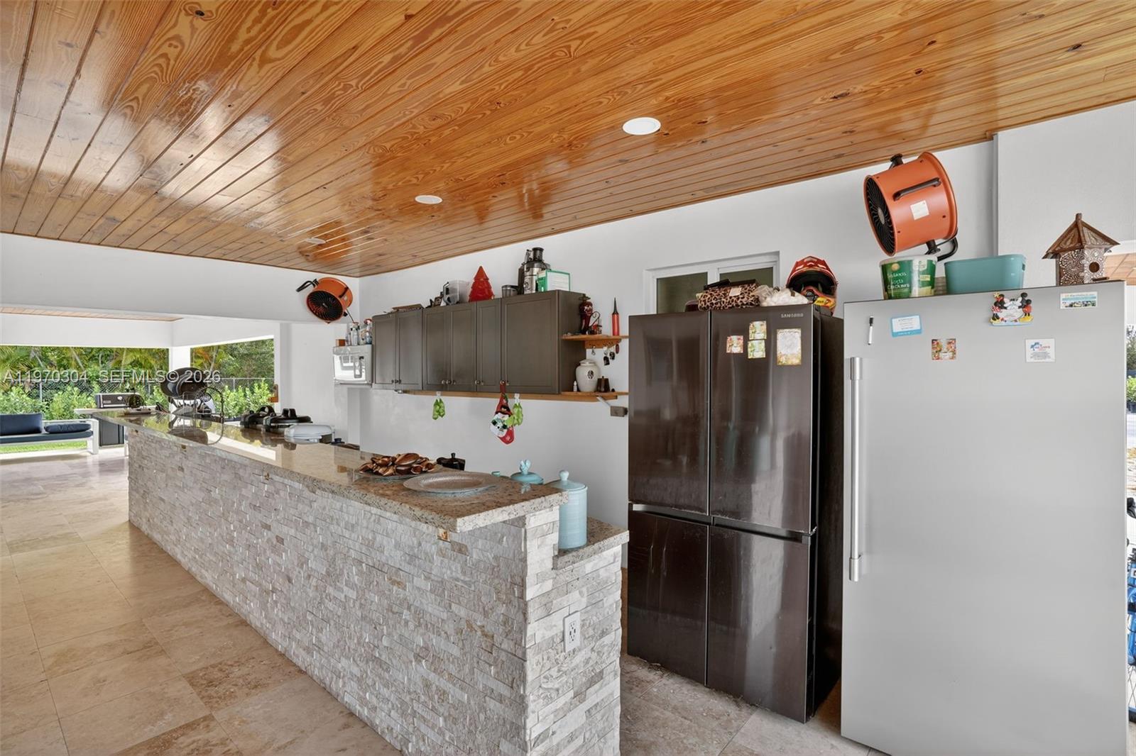19390 Southwest 312th Street Homestead, FL 33030 - Photo 32 of 41 a kitchen with stainless steel appliances granite countertop a refrigerator a stove and a sink with wooden floor