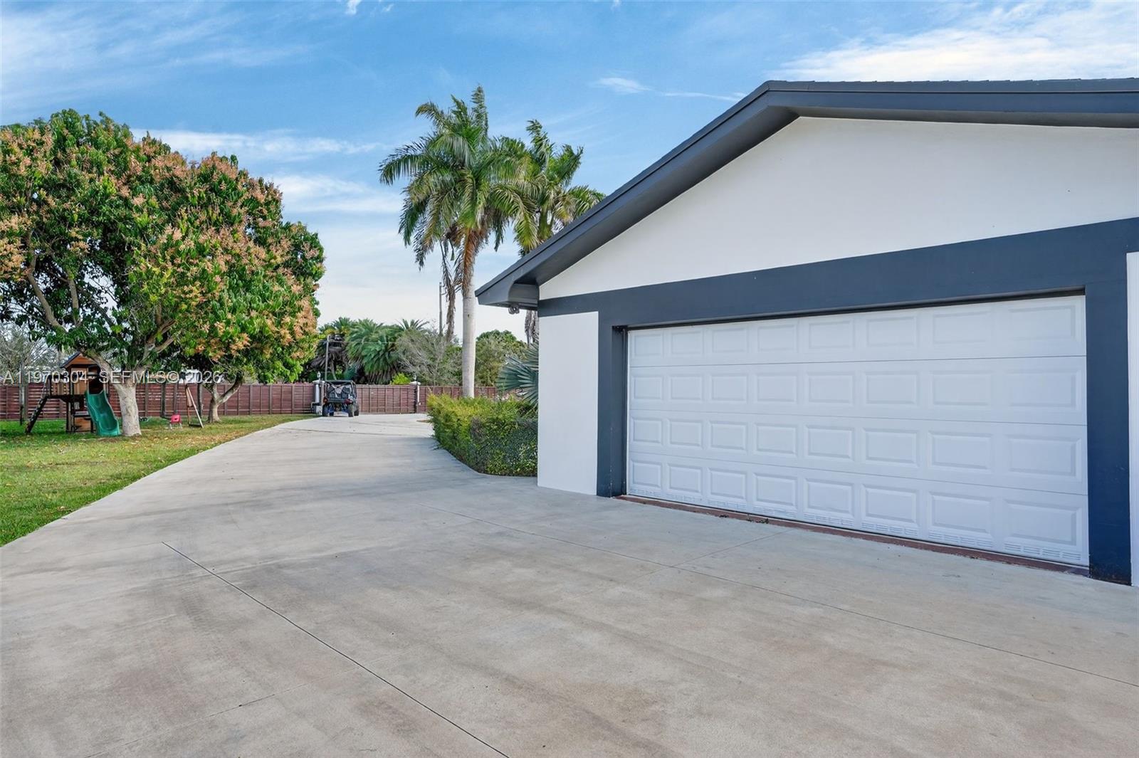 19390 Southwest 312th Street Homestead, FL 33030 - Photo 41 of 41 a view of a house with a yard and garage