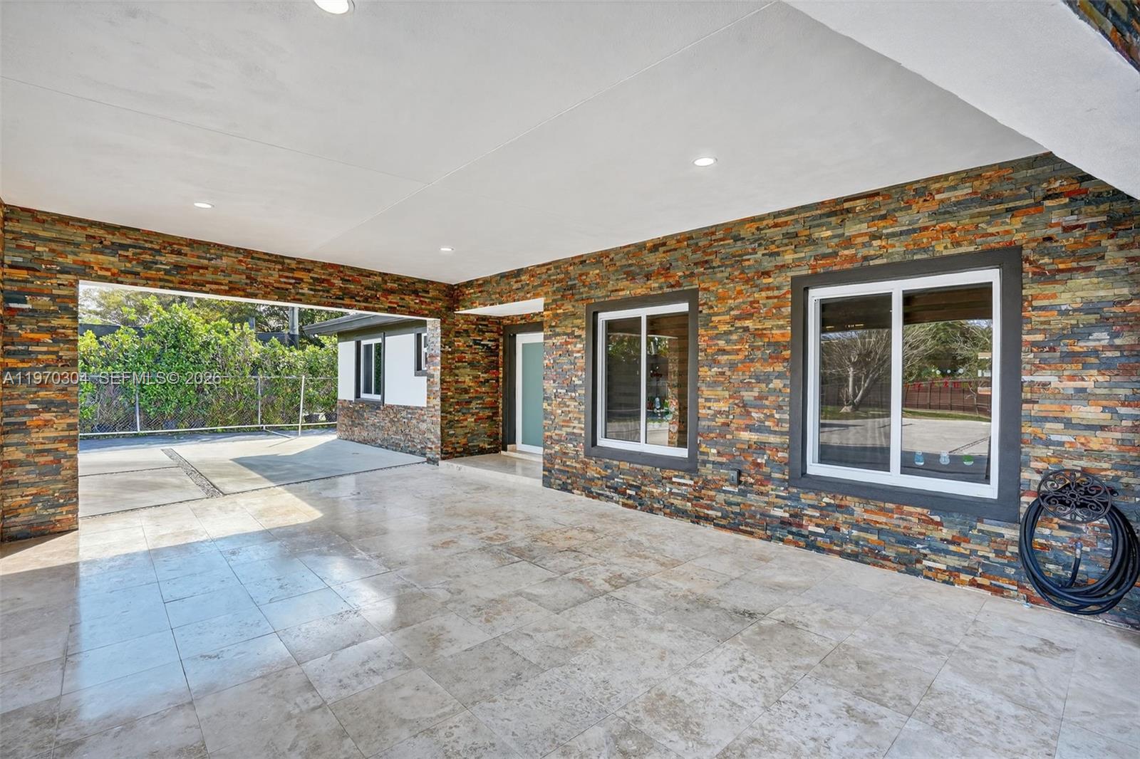 19390 Southwest 312th Street Homestead, FL 33030 - Photo 5 of 41 a view of a house with a backyard and a porch
