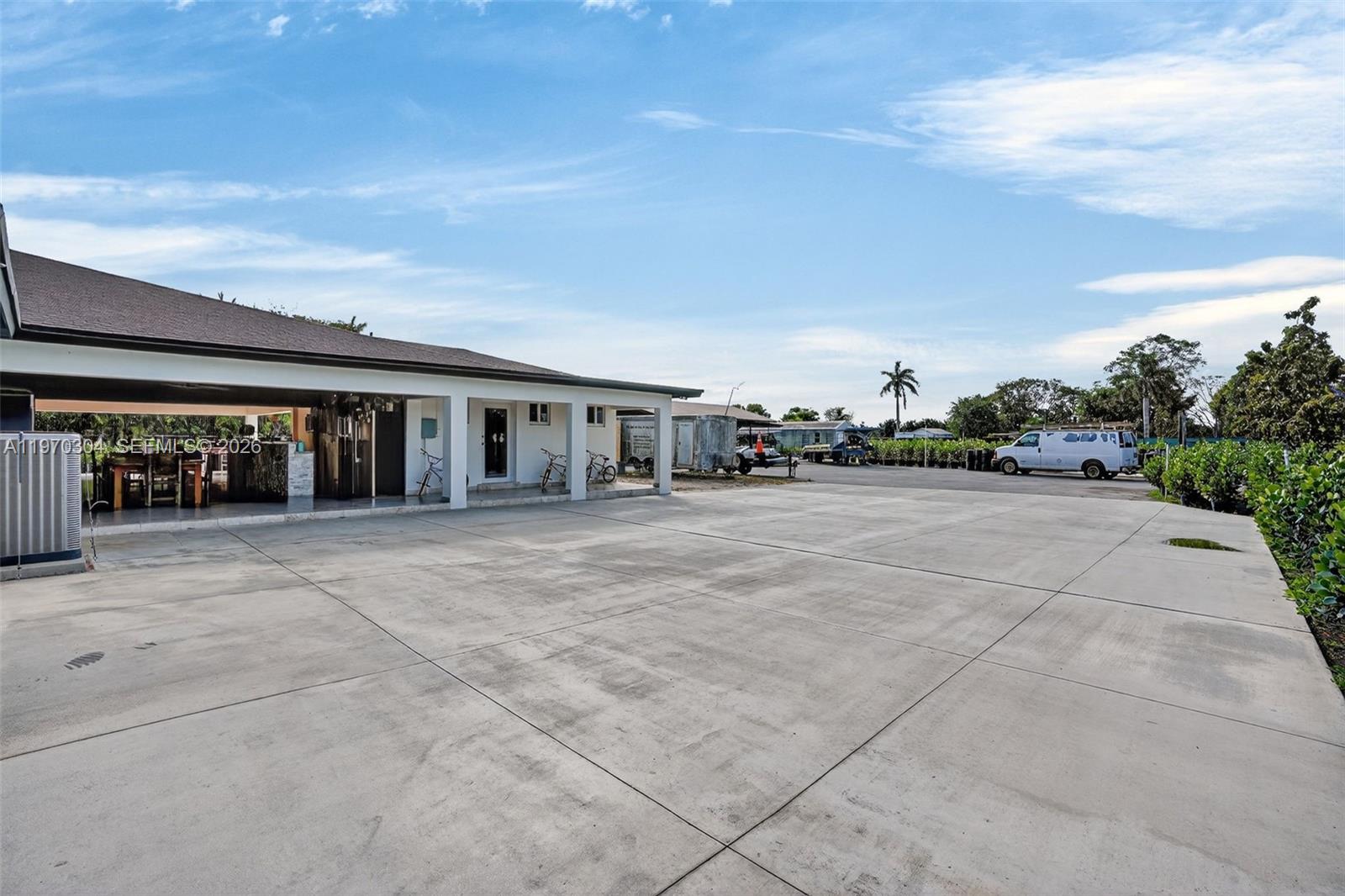 19390 Southwest 312th Street Homestead, FL 33030 - Photo 6 of 41 a view of house with outdoor space and tall trees
