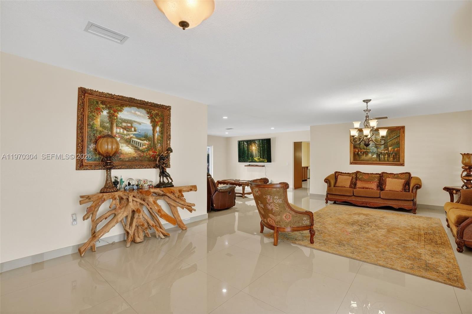 19390 Southwest 312th Street Homestead, FL 33030 - Photo 7 of 41 a living room with furniture and a flat screen tv