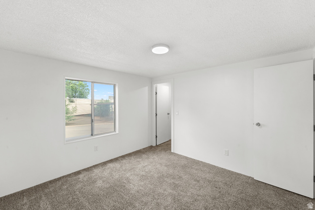 2875 North 400 West, Unit 7 Layton, UT 84041 - Photo 18 of 29 Carpeted interior space featuring a window with exterior views, white walls, and a flush-mount ceiling light