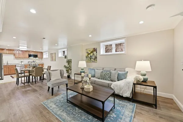 a kitchen with stainless steel appliances granite countertop a stove top oven a sink dishwasher a refrigerator and a microwave