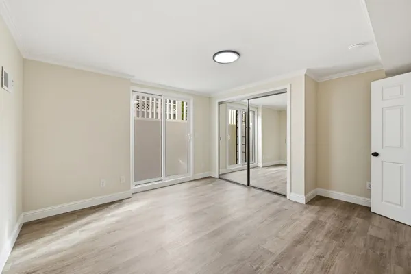 a bathroom with a granite countertop sink a toilet a mirror and shower