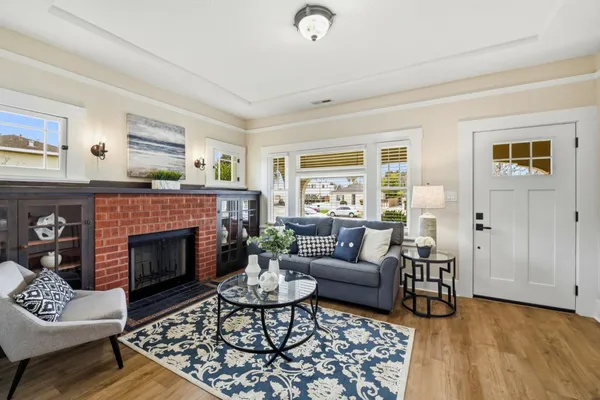 a living room with furniture and a fireplace