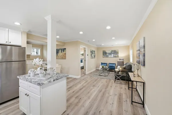 a kitchen with a sink a stove a refrigerator and cabinets