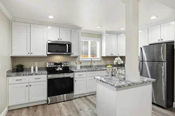 a bedroom with a large bed and a potted plant