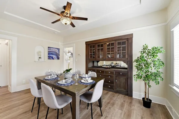 a view of a dining room with furniture and wooden floor