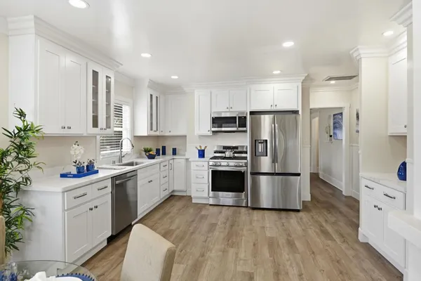 a kitchen with stainless steel appliances a refrigerator sink and cabinets