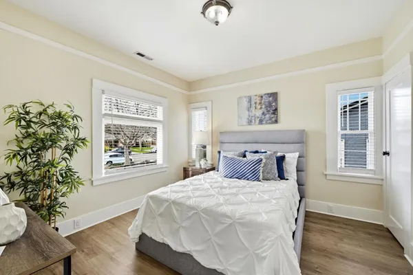 a bedroom with a bed and a potted plant
