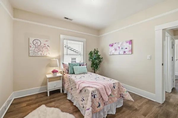 a bedroom with a bed and a window