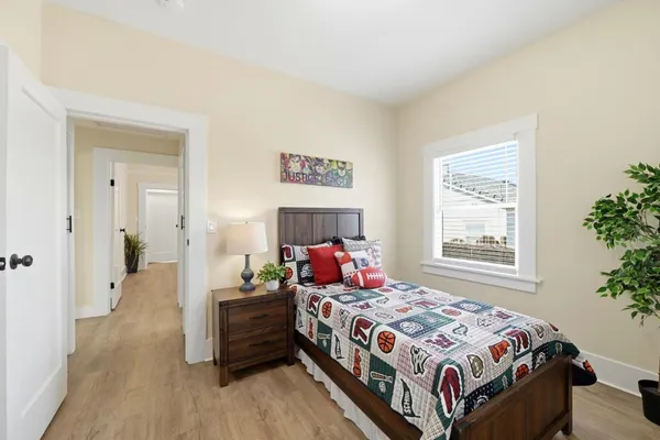 a bedroom with a bed and a window