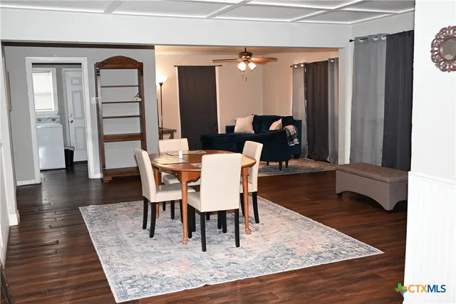 a dining room with furniture and wooden floor