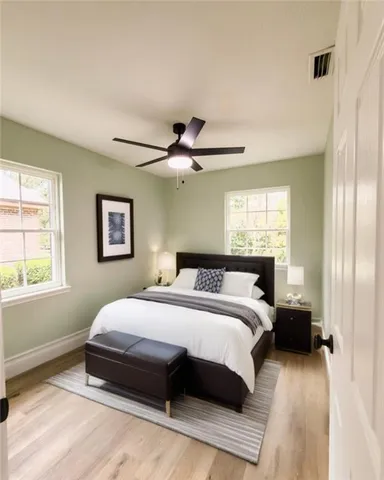 a bedroom with a large bed and a window