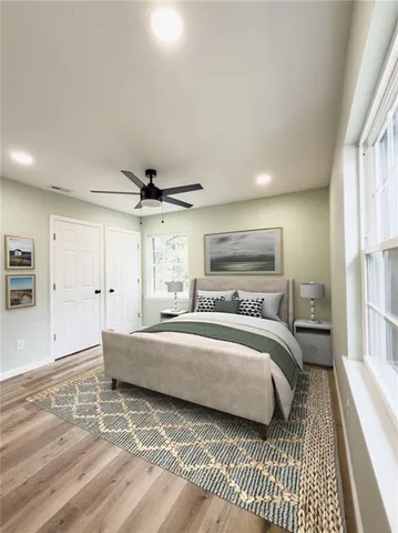 a bedroom with a bed and a window