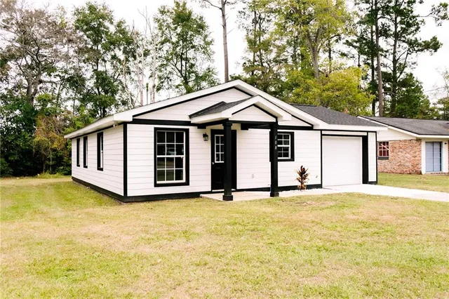 a big house with a big yard and large trees
