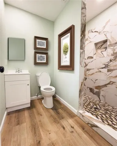 a bathroom with a toilet sink and mirror