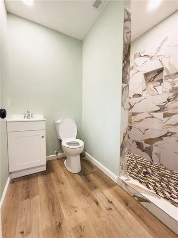 a bathroom with a toilet and a shower