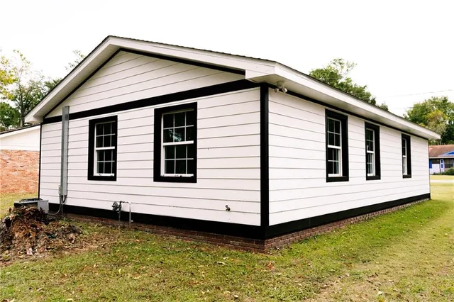 a view of a house with a wooden deck