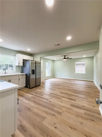a view of a kitchen with a sink and a refrigerator