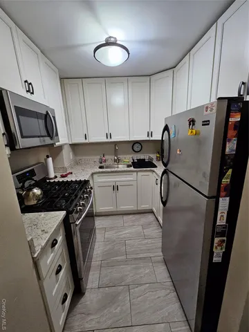 a kitchen with a stove a refrigerator and a sink