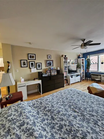 a living room with furniture a rug and a large window