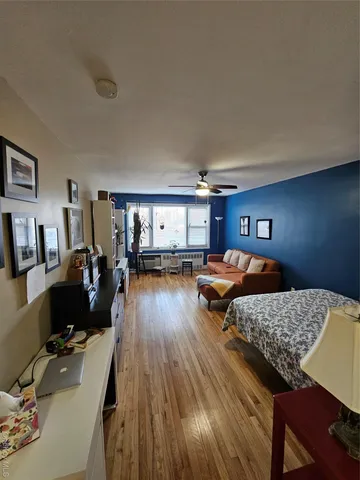 a bedroom with furniture and a wooden floor