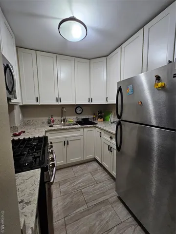 a kitchen with cabinets and appliances
