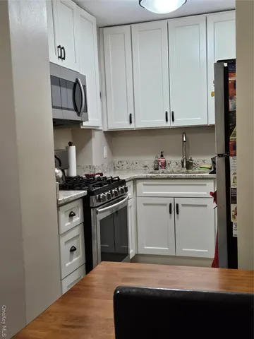 a kitchen with stainless steel appliances a stove sink and cabinets