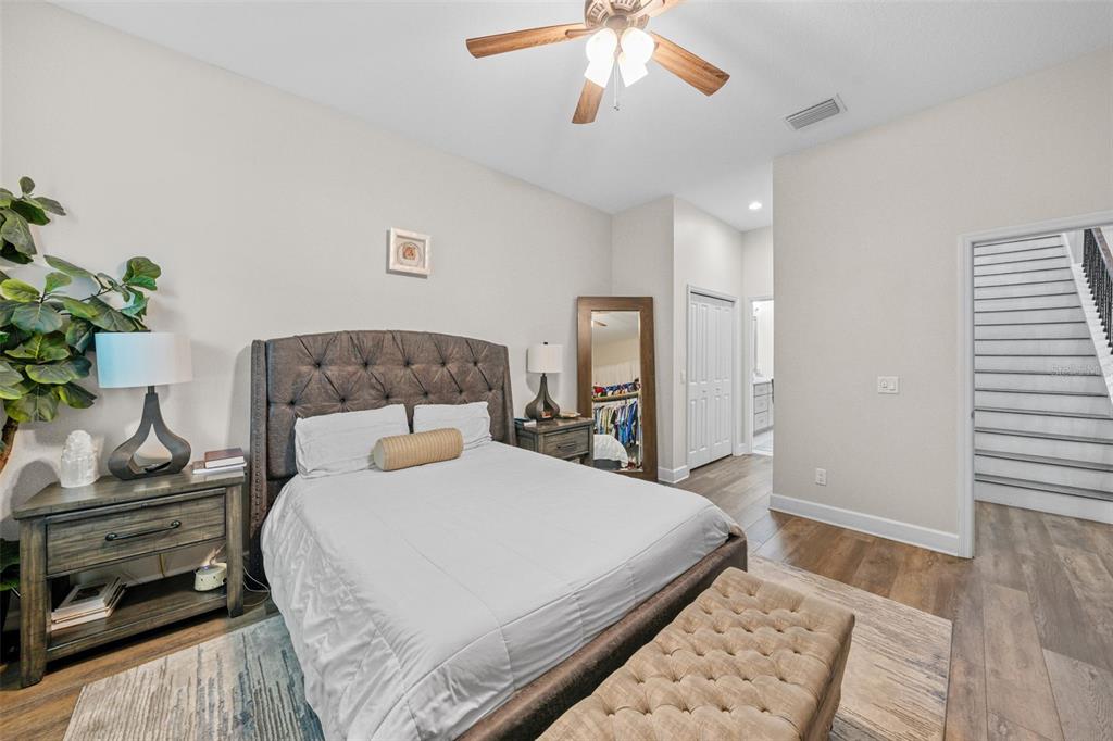 1404 Ridge Terrace Tarpon Springs, FL 34689 - Photo 11 of 38 a bedroom with a large bed and a chandelier