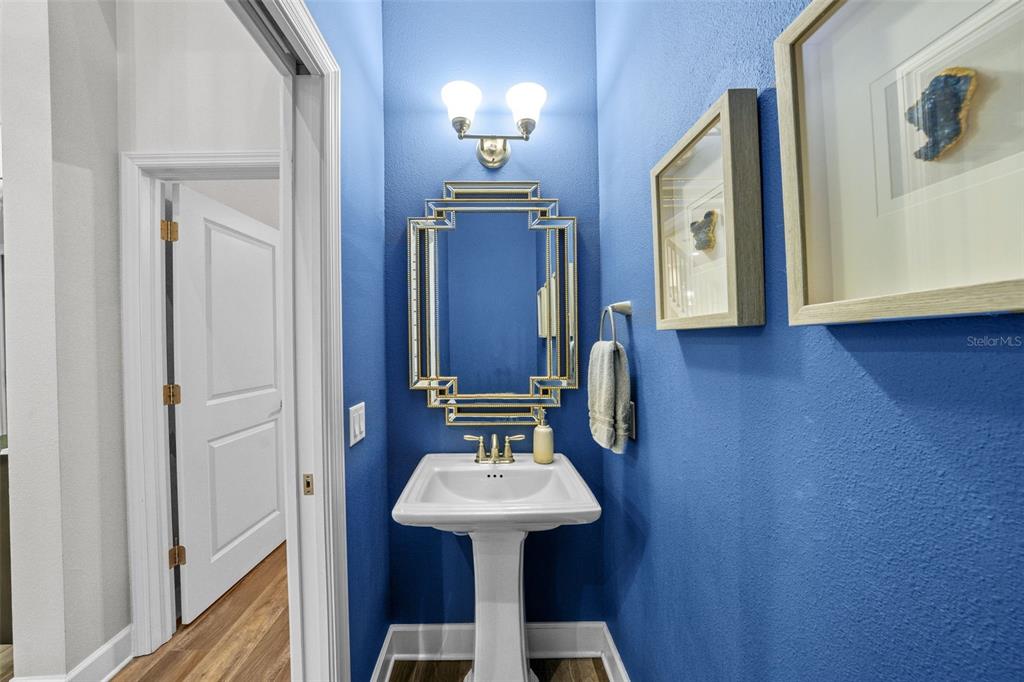 1404 Ridge Terrace Tarpon Springs, FL 34689 - Photo 18 of 38 a bathroom with a sink a mirror and a toilet