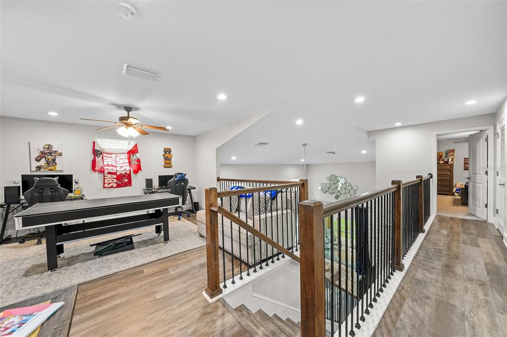 1404 Ridge Terrace Tarpon Springs, FL 34689 - Photo 19 of 38 a view of a hallway with wooden floor and furniture