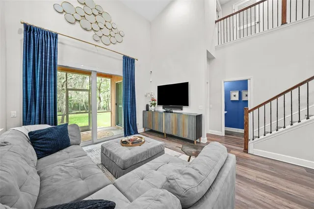 a living room with furniture tv and a window