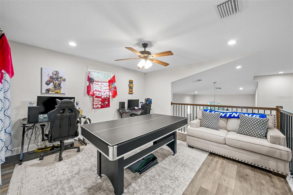 1404 Ridge Terrace Tarpon Springs, FL 34689 - Photo 22 of 38 a living room with furniture and a flat screen tv