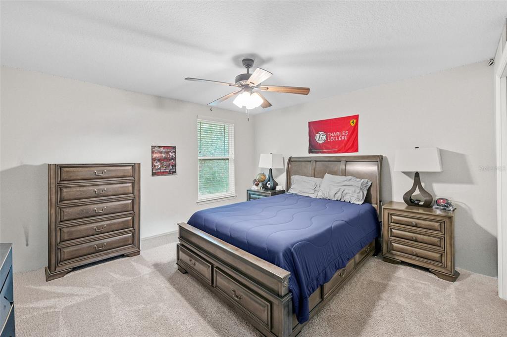 1404 Ridge Terrace Tarpon Springs, FL 34689 - Photo 28 of 38 a bedroom with a bed and a chandelier