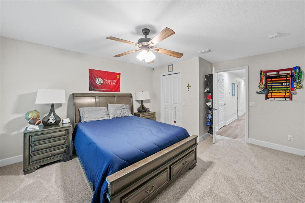 1404 Ridge Terrace Tarpon Springs, FL 34689 - Photo 30 of 38 a bedroom with a bed and a chandelier