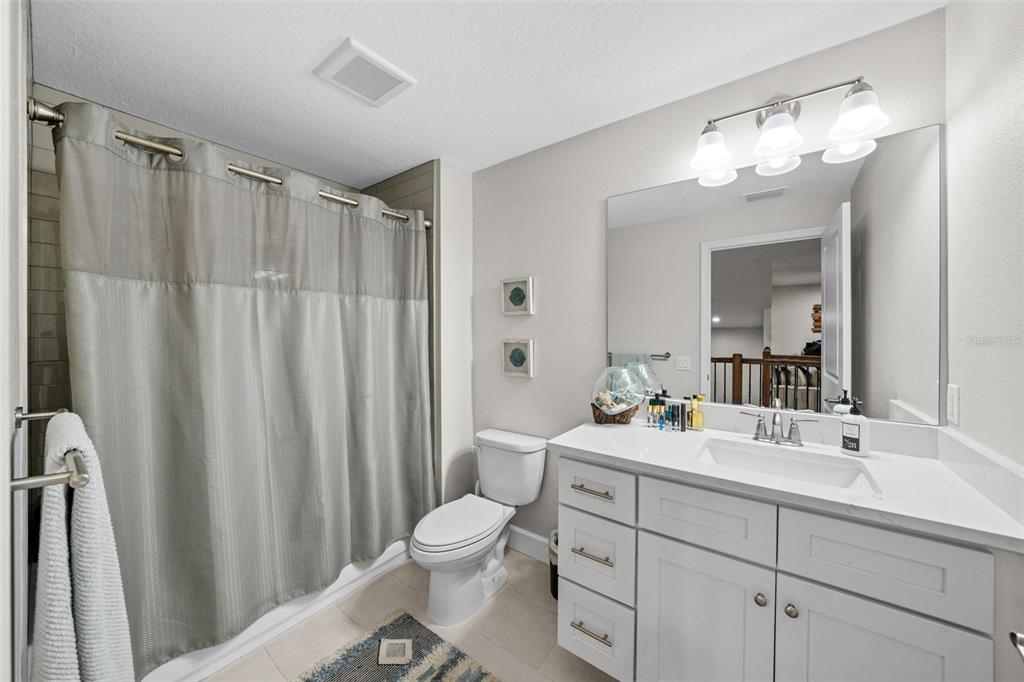 1404 Ridge Terrace Tarpon Springs, FL 34689 - Photo 31 of 38 a bathroom with a double vanity sink mirror and toilet