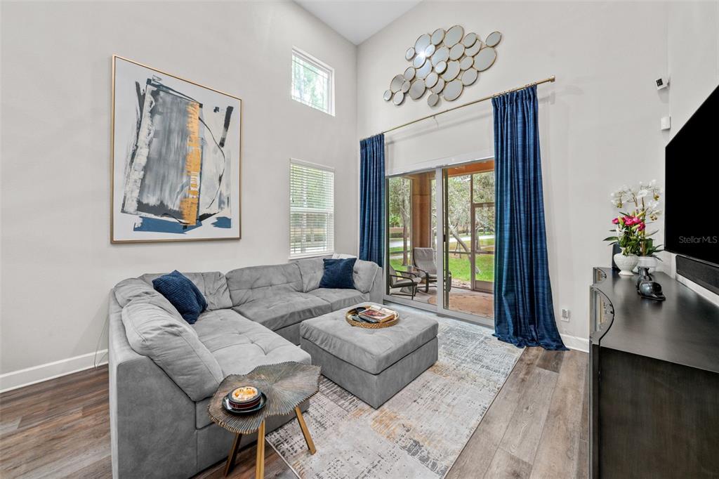 1404 Ridge Terrace Tarpon Springs, FL 34689 - Photo 4 of 38 a living room with furniture a flat screen tv and a large window