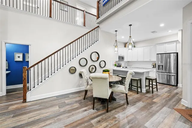 a dining room with wooden floor a table and chairs