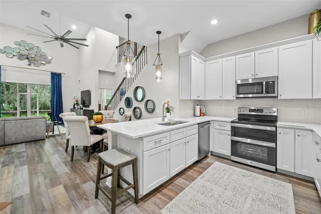 a kitchen that has a lot of cabinets in it and appliances