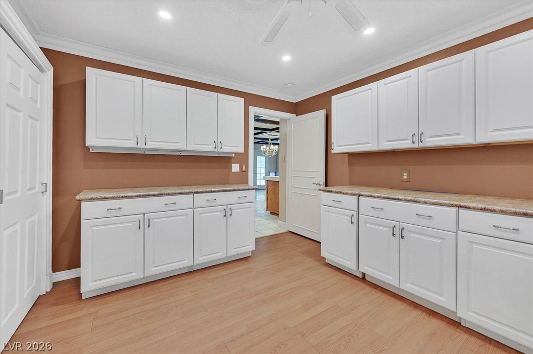 3618 Fieldcrest Road Las Vegas, NV 89121 - Photo 26 of 36 Ample white cabinetry lines the walls of this versatile room, offering generous storage.