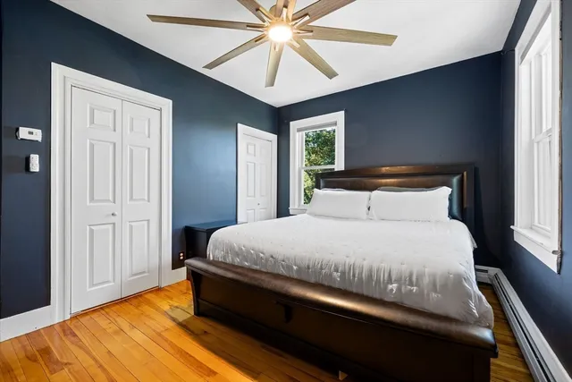 a bed sitting in a bedroom next to a window