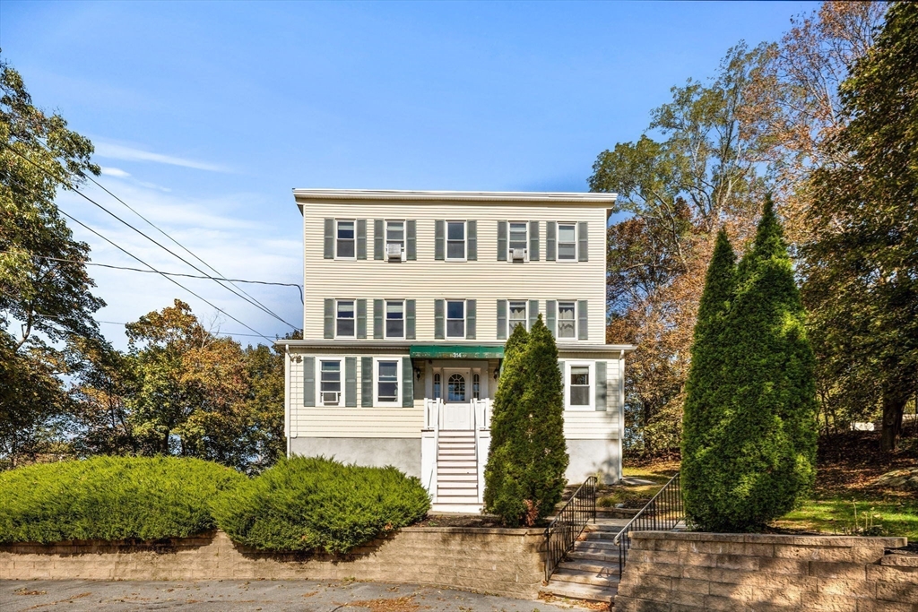 314 Water Street, Unit 5 Wakefield, MA 01880 - Photo 19 of 20 a front view of a house with a yard