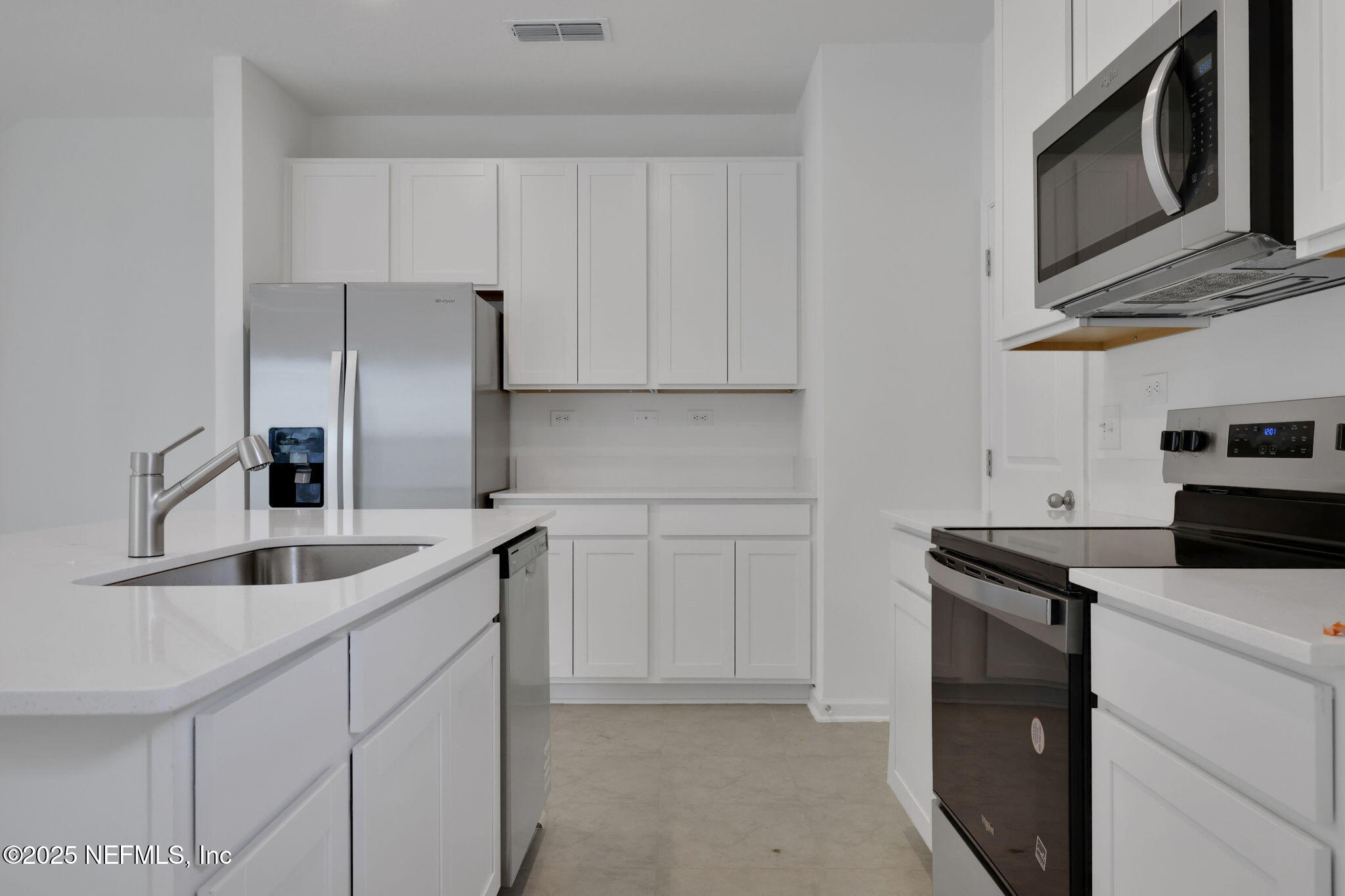 3786 Athenian Way Middleburg, FL 32068 - Photo 5 of 25 a kitchen with stainless steel appliances granite countertop a sink and a refrigerator
