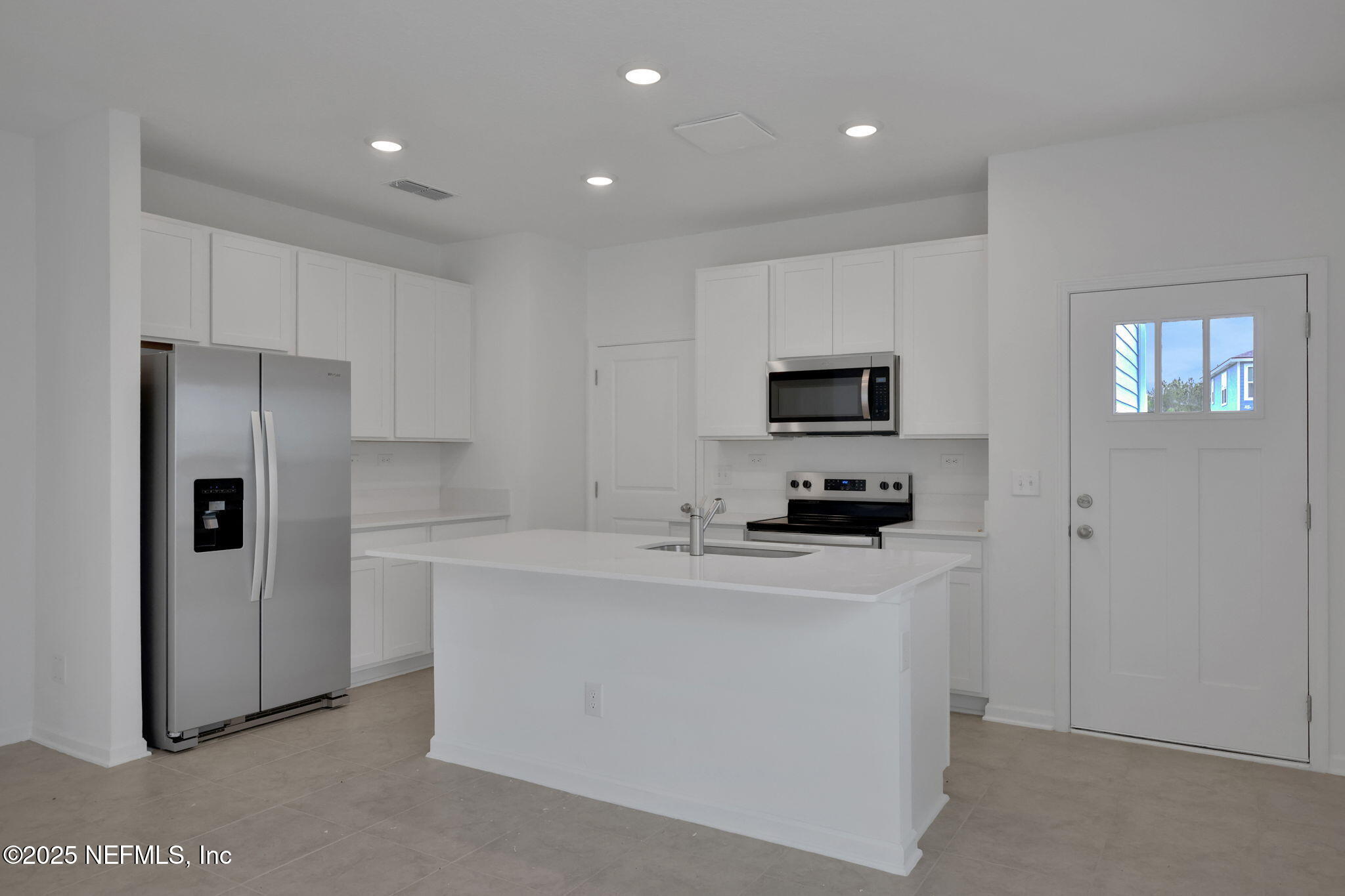 3786 Athenian Way Middleburg, FL 32068 - Photo 7 of 25 a kitchen with stainless steel appliances a refrigerator a stove a microwave and a refrigerator