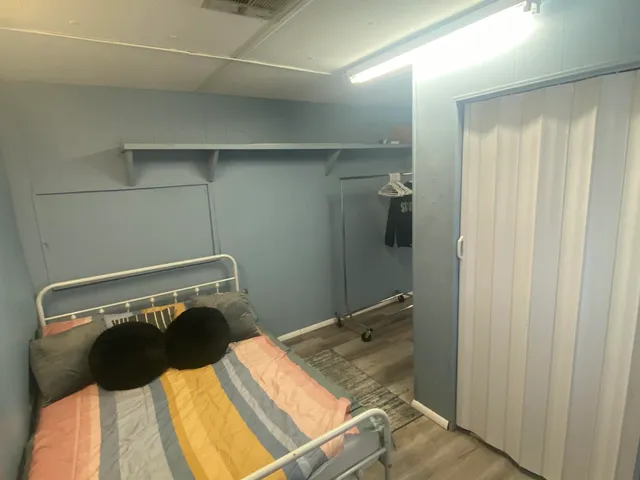 a view of a room with wooden floor and furniture