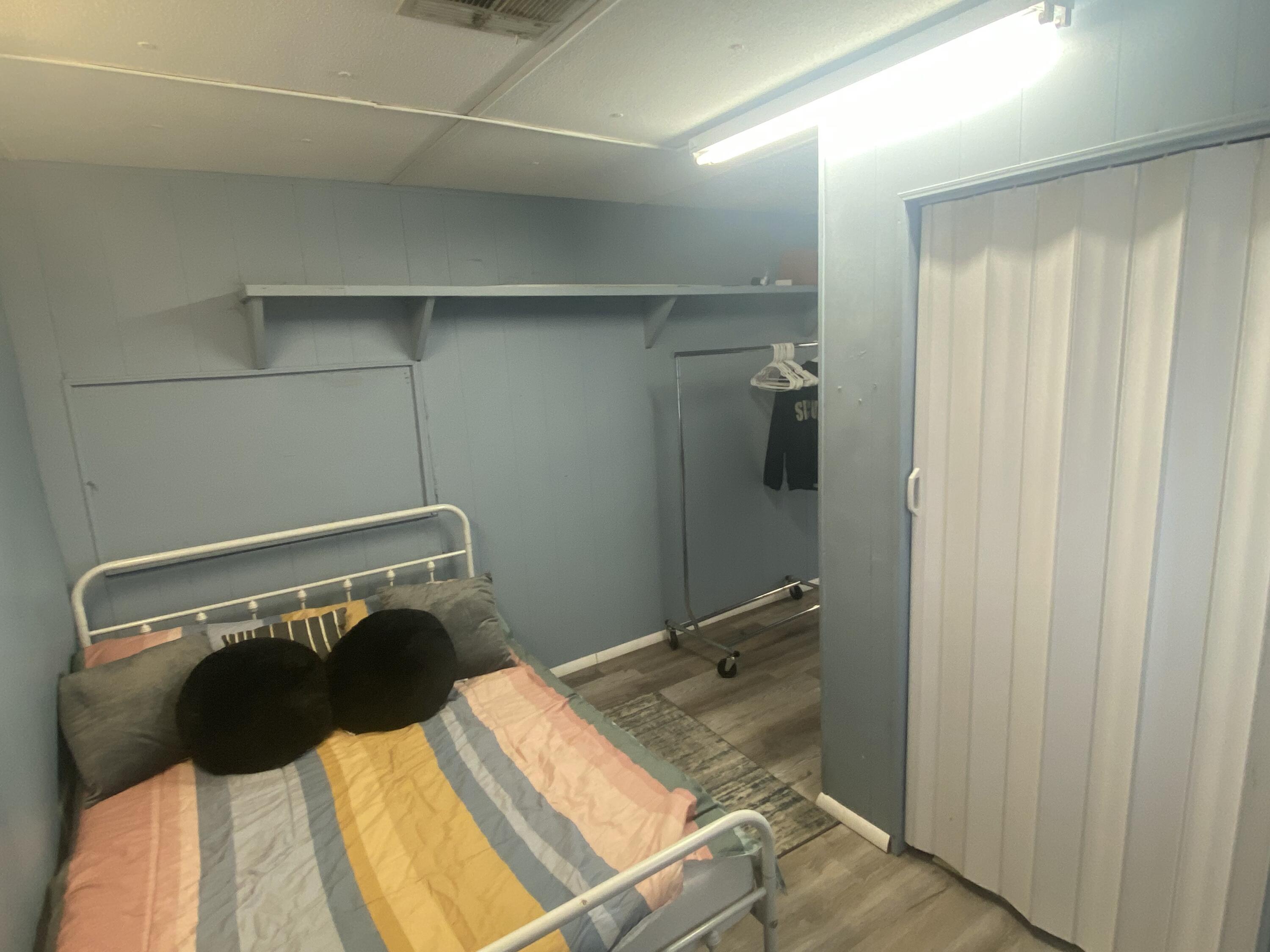 2141 B Road, Unit 4 Loxahatchee Groves, FL 33470 - Photo 11 of 43 a bedroom with a bed and walk in closet