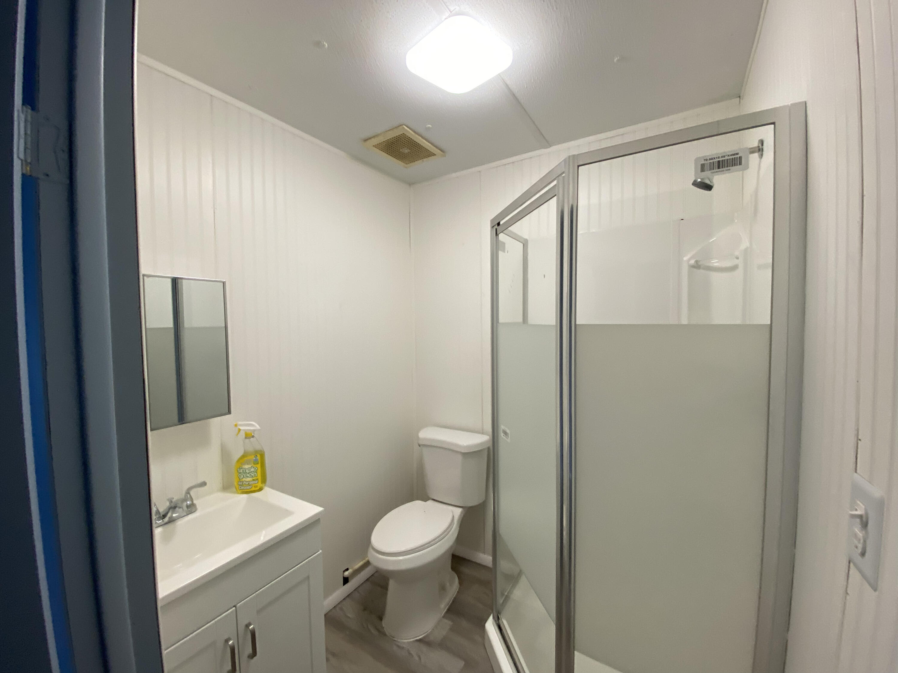 2141 B Road, Unit 4 Loxahatchee Groves, FL 33470 - Photo 12 of 43 a bathroom with a toilet a sink and mirror