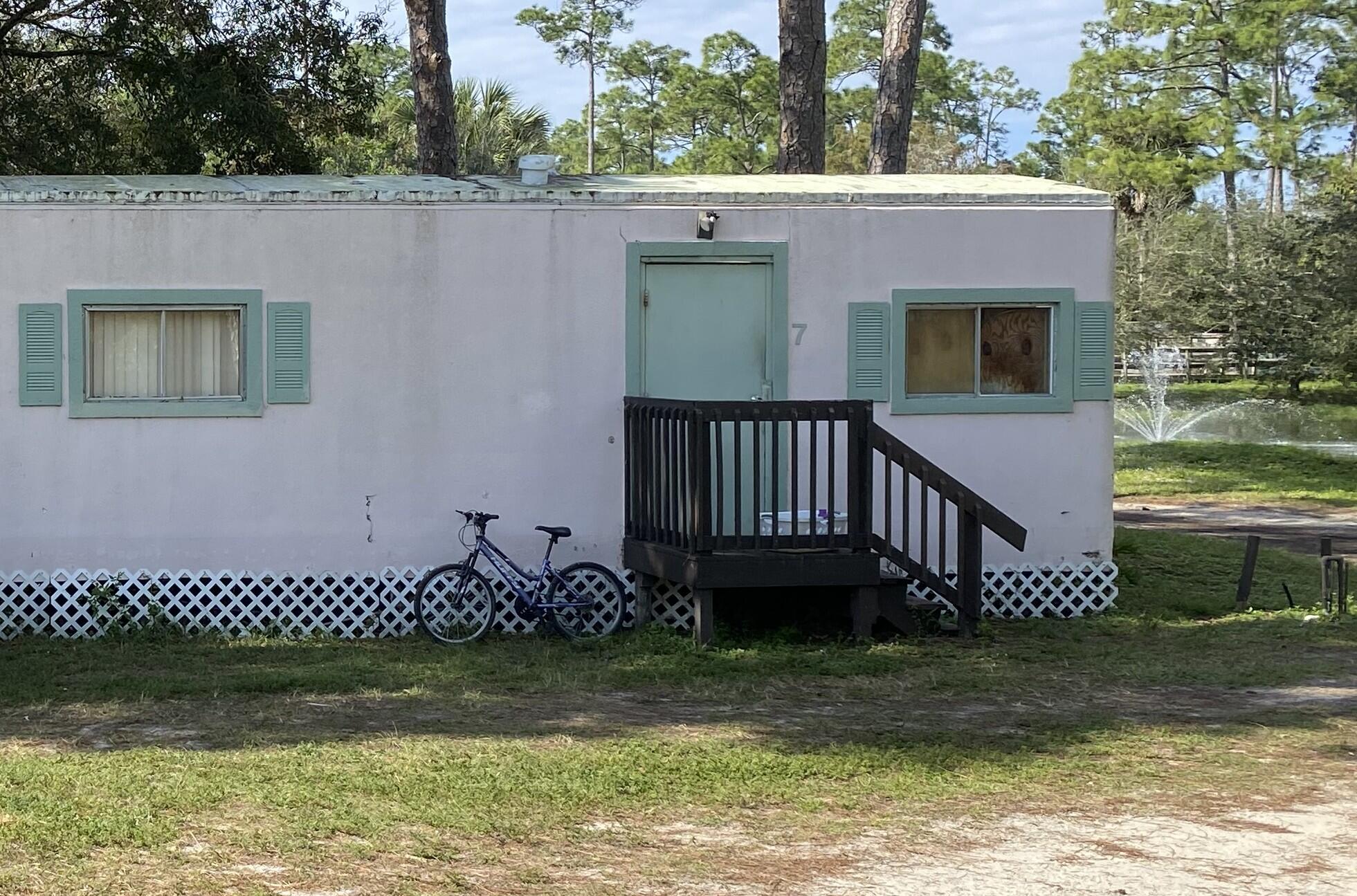 2141 B Road, Unit 4 Loxahatchee Groves, FL 33470 - Photo 15 of 43 a view of a house with a yard