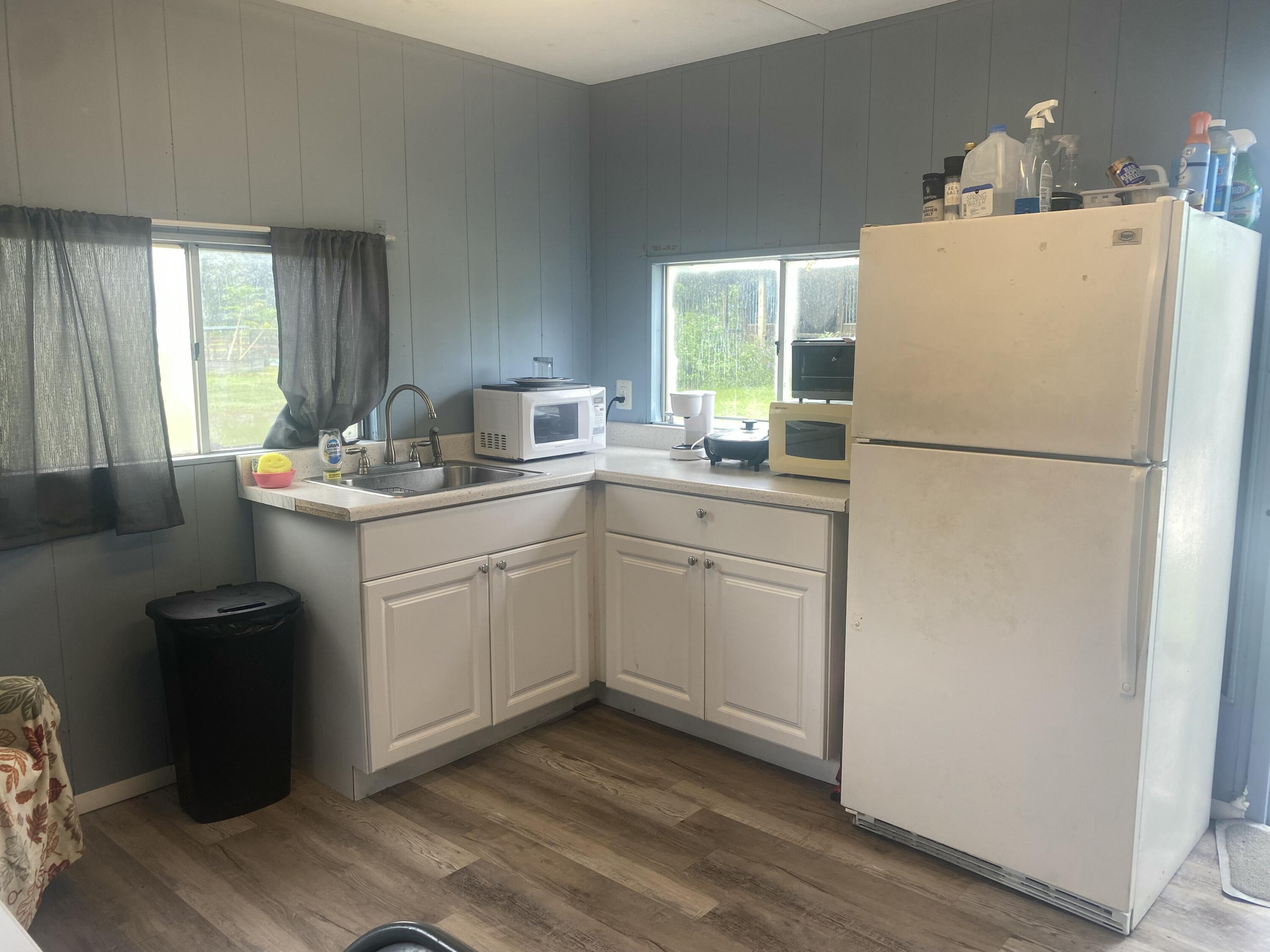 2141 B Road, Unit 4 Loxahatchee Groves, FL 33470 - Photo 3 of 43 a white refrigerator freezer sitting inside of a kitchen